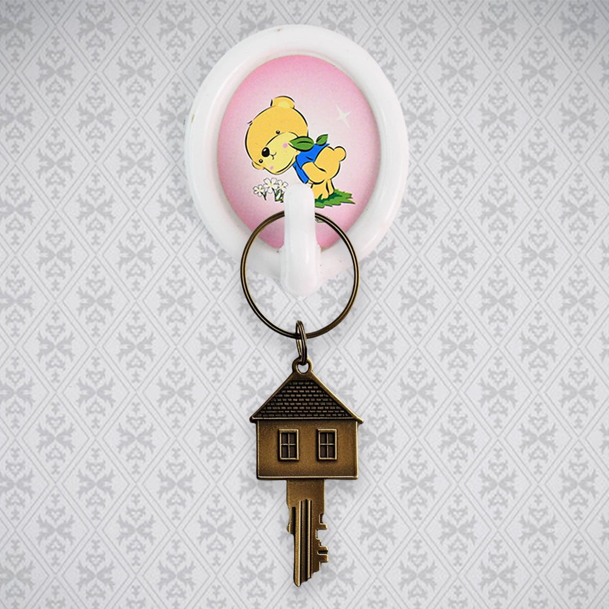 A smiley wall hook holding a kitchen ladle, demonstrating its functionality in a modern kitchen setting.