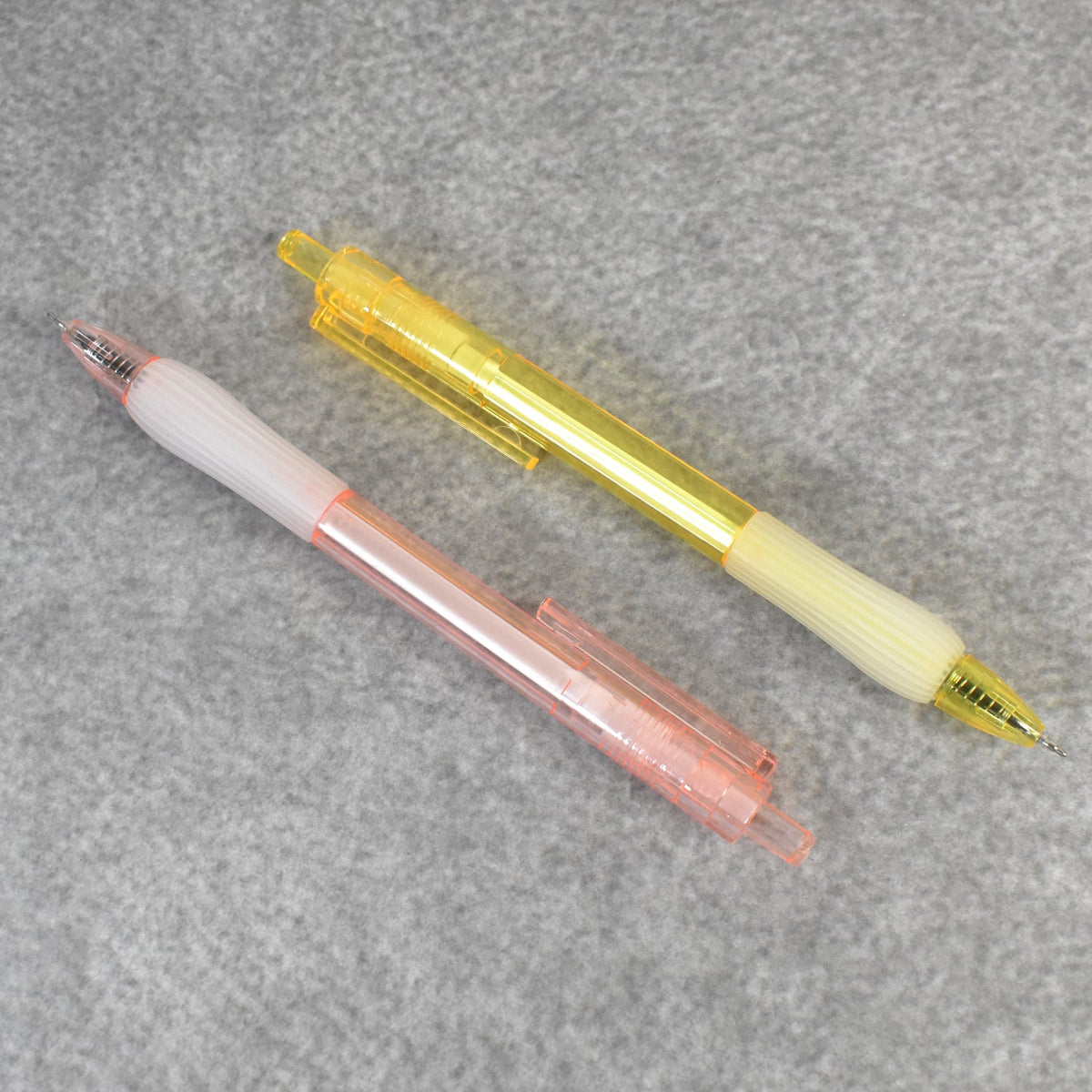 A pair of CustoPen ballpoint pens displayed with essential office stationery.