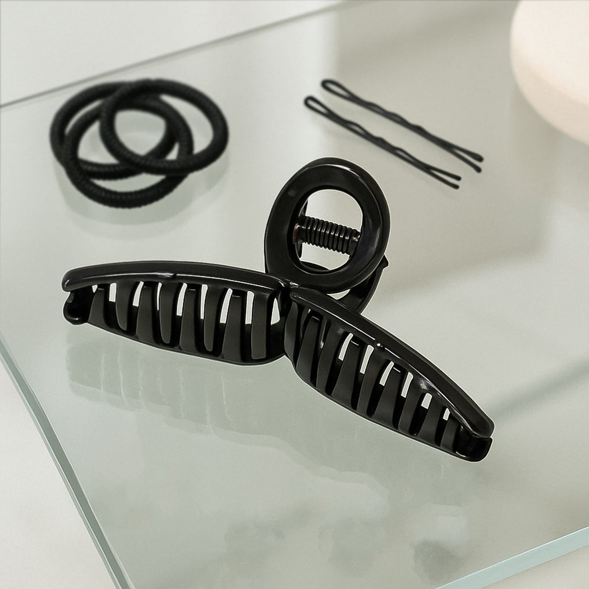 Back view of woman wearing hair claw clip holding elegant updo securely