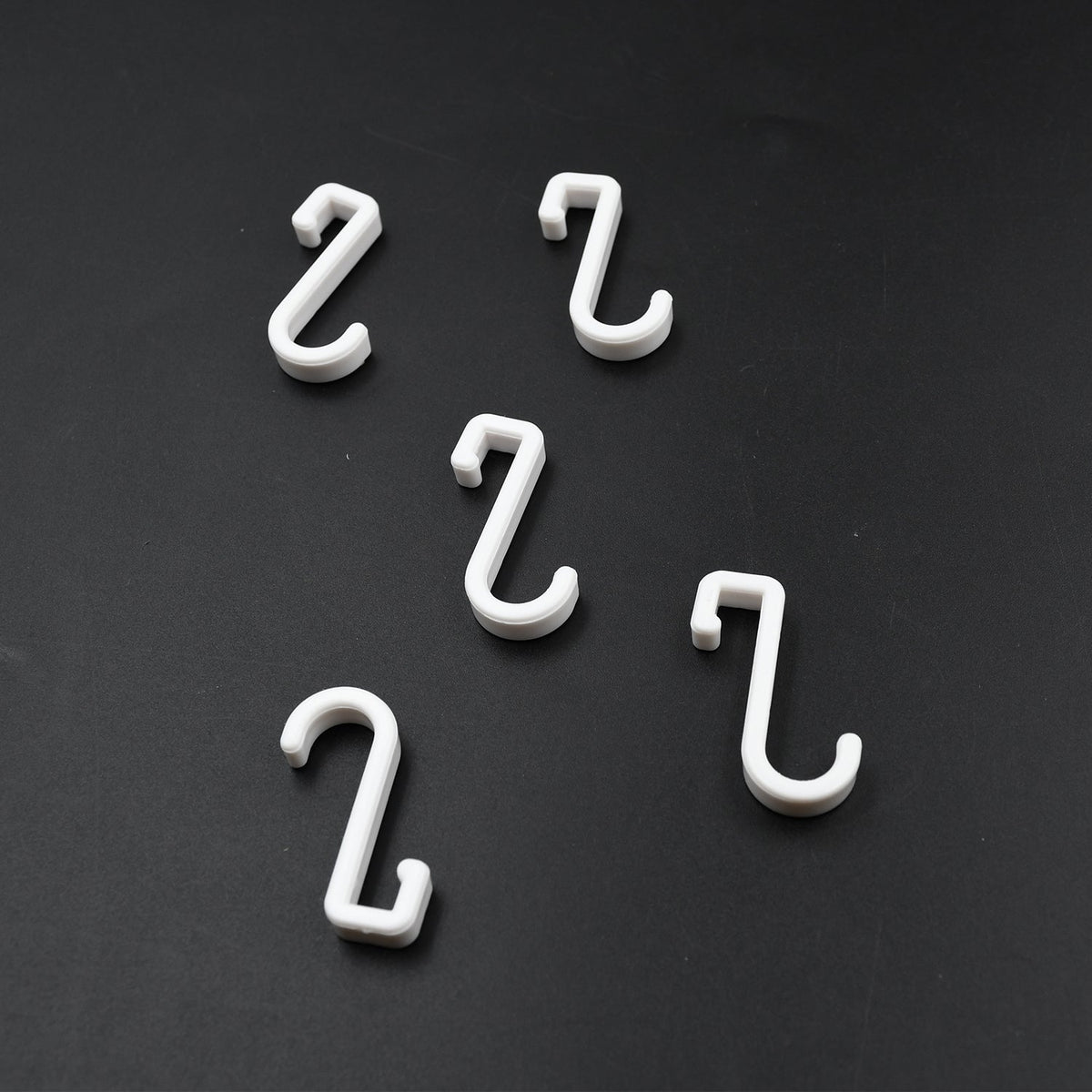 Multi-angle view of the strong self-adhesive plastic hook, highlighting its sleek design.