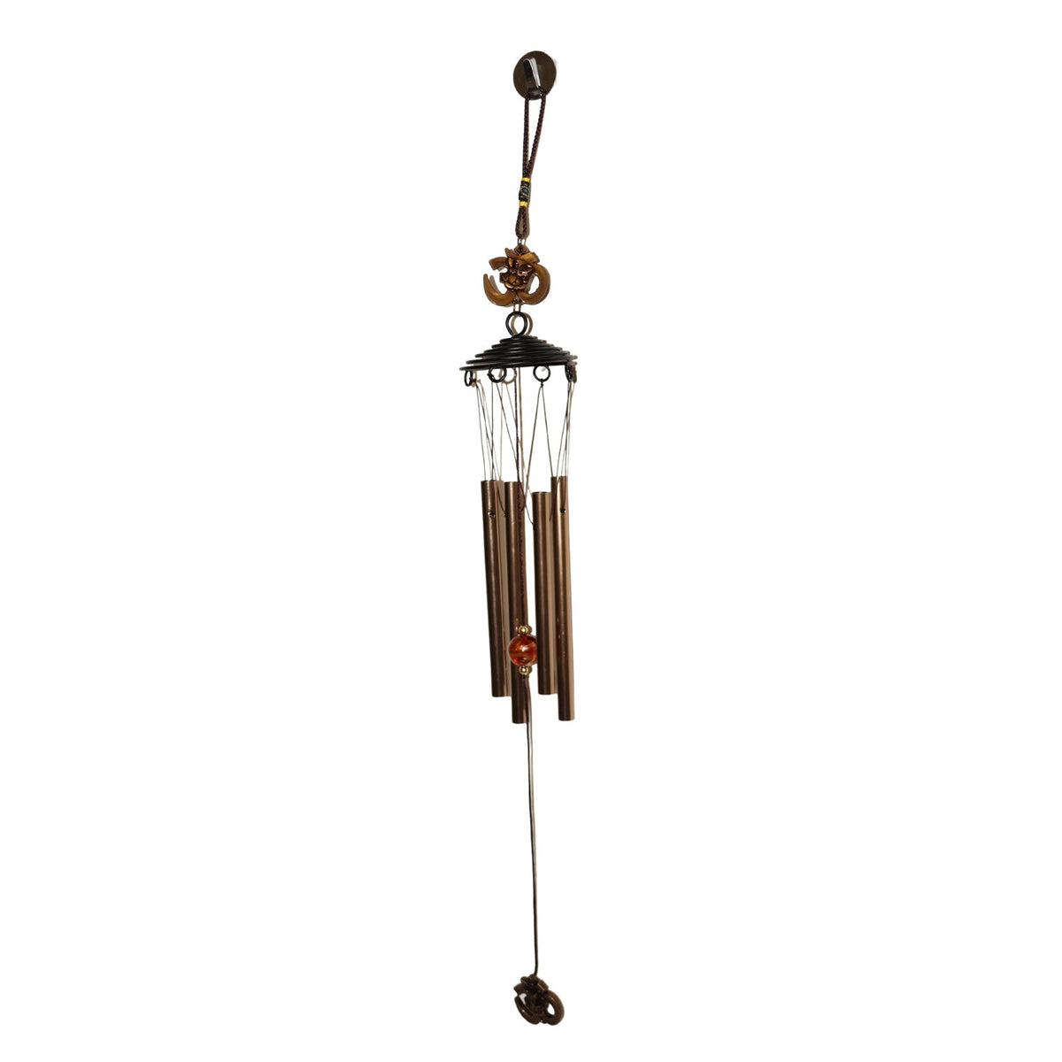 Side view of metal wind chime with Om symbol against green background