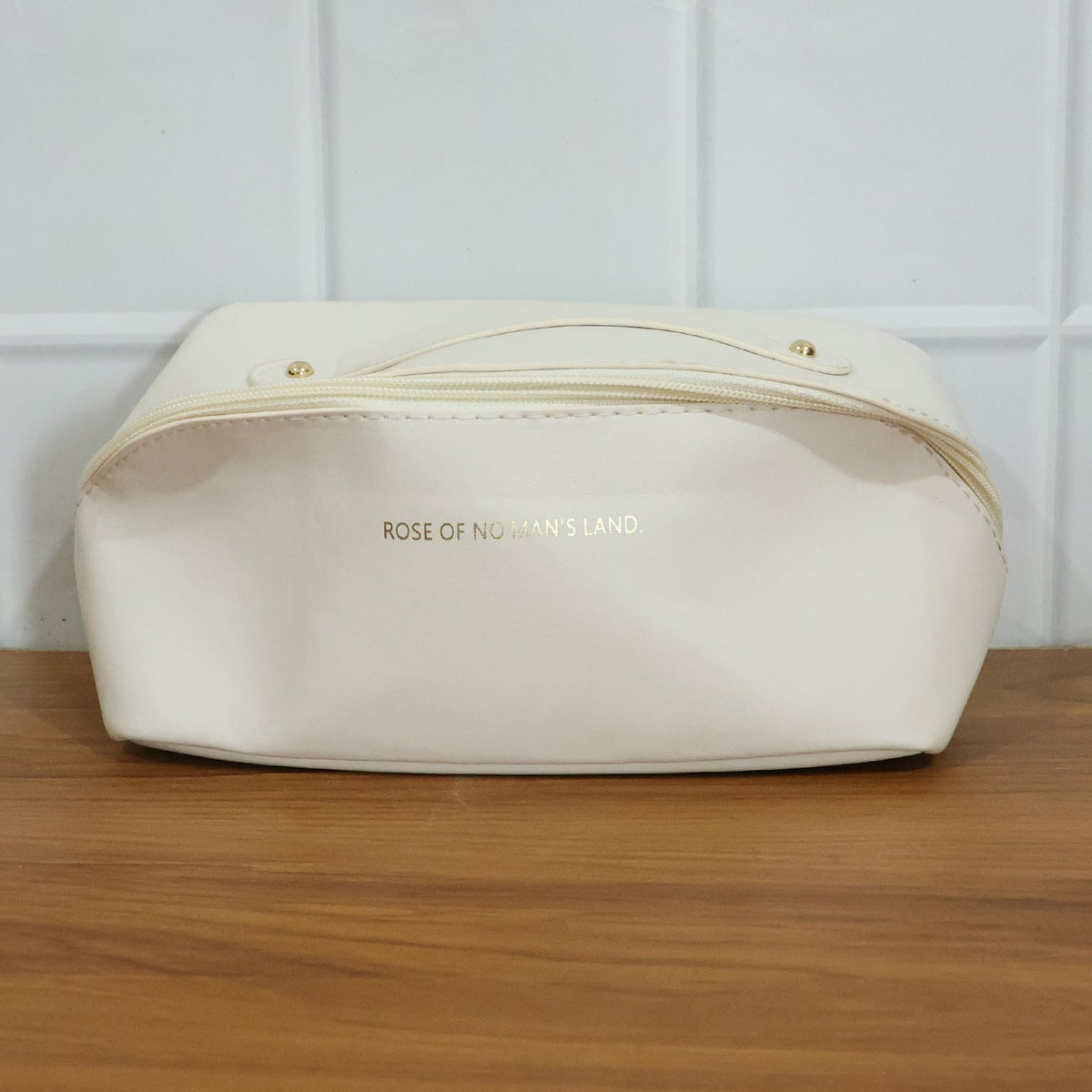 Open travel organizer pouch displaying internal compartments for toiletries