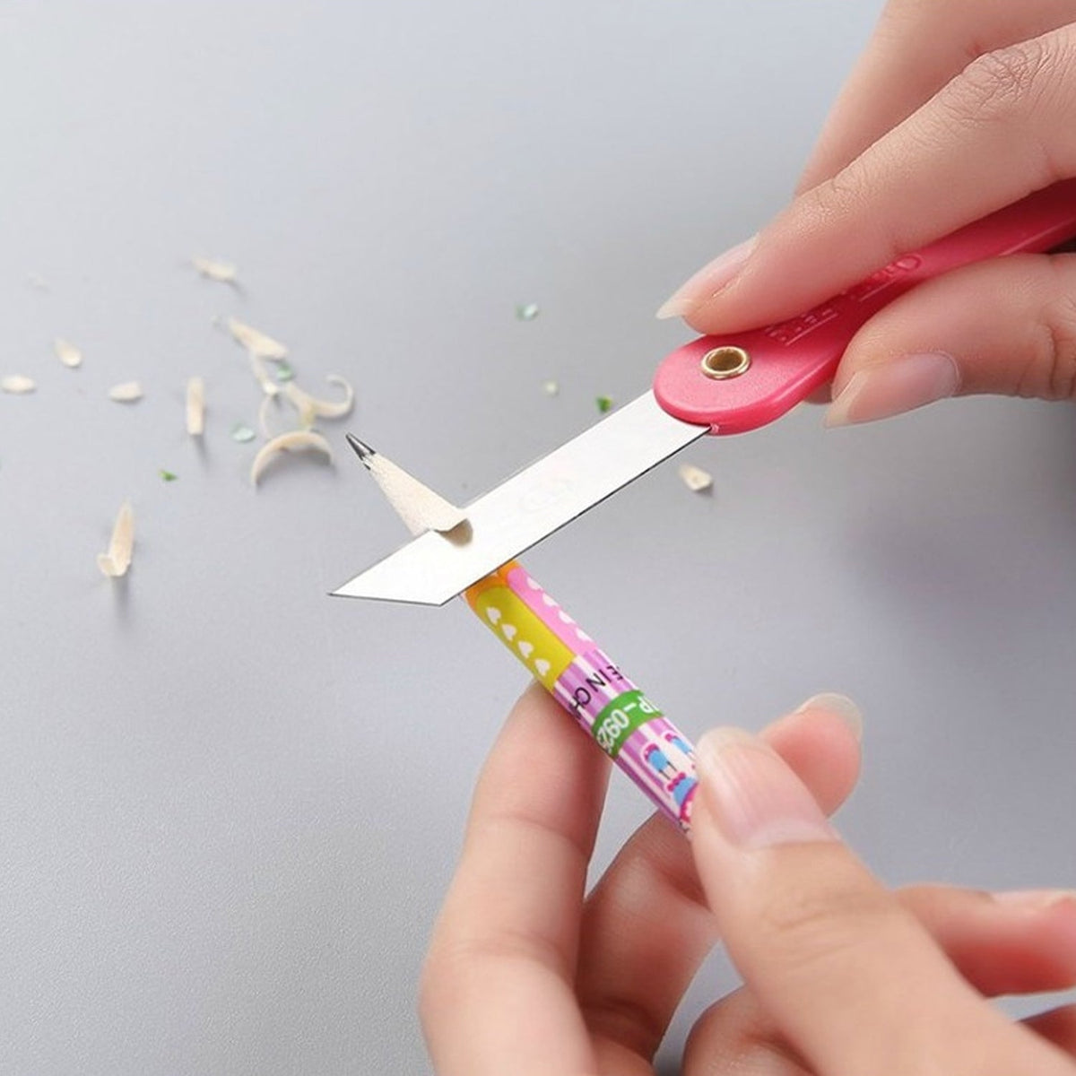 Vibrant multicolour handle of a mini paper cutter knife showing ergonomic design.