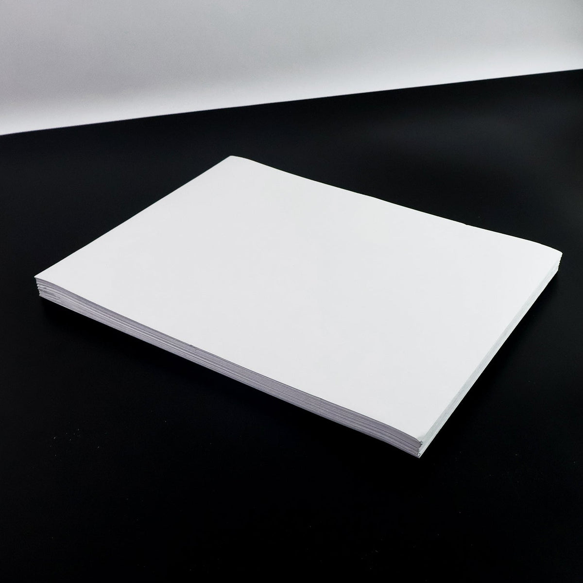 White A4 self-adhesive label sheets stacked neatly for printing