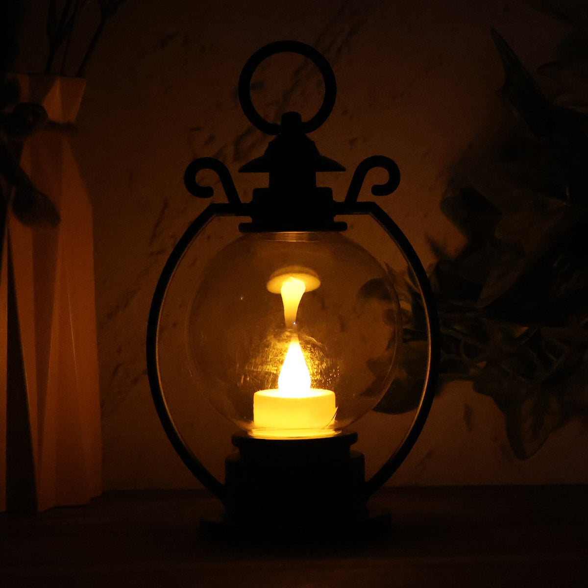 Decorative LED storm lantern displaying flickering flame effect on table
