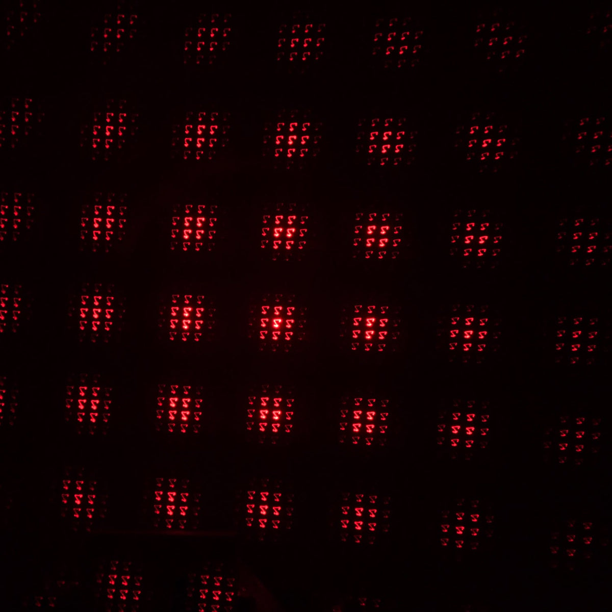 A galaxy projector creating a romantic starry night effect in a dimly lit room.