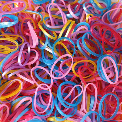 Vibrant multicolor rubber bands neatly stacked in a pile.