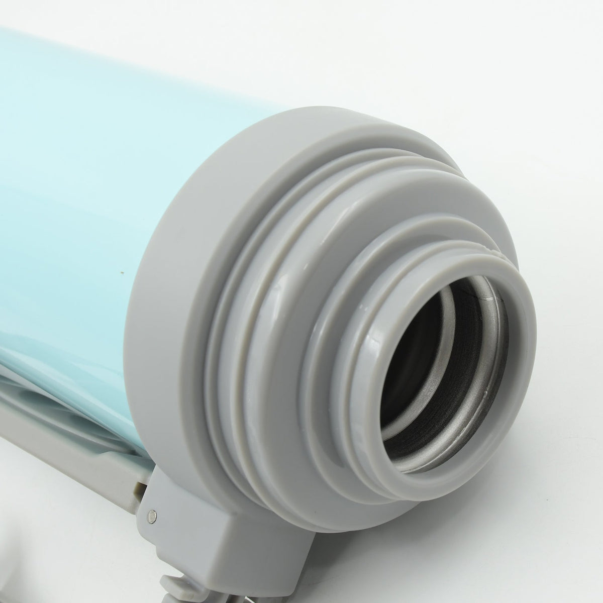 Stainless steel thermos pouring a refreshing drink into a cup.
