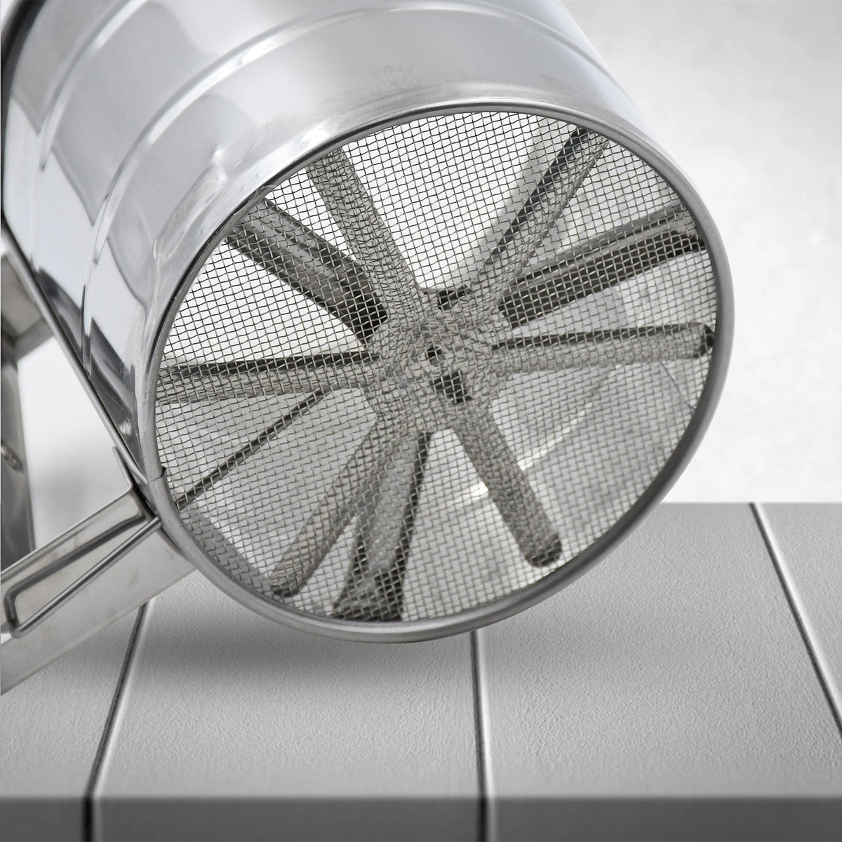 Multipurpose stainless steel flour sifter, an essential kitchen tool for baking.