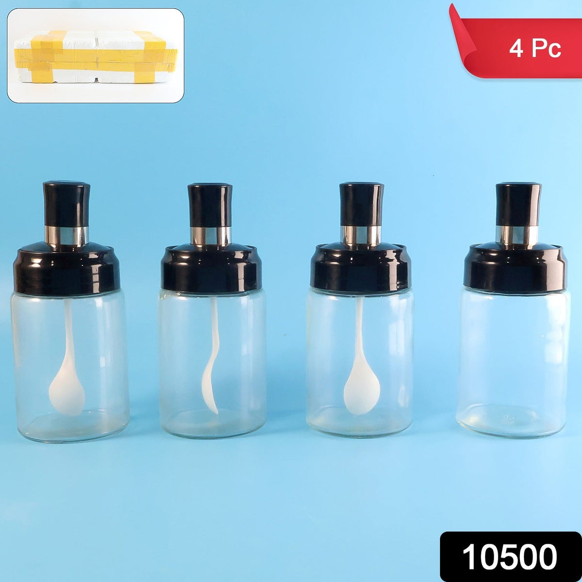 Set of four clear spice storage bottles with built-in spoons and airtight lids