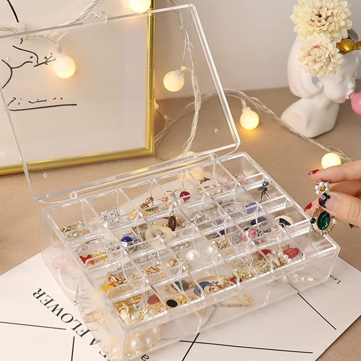 Top-down view of the open acrylic jewelry box revealing its spacious two-layer design.