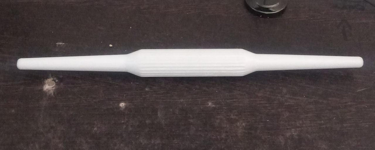 Sturdy plastic rolling pin with anti-skid base for stable operation.